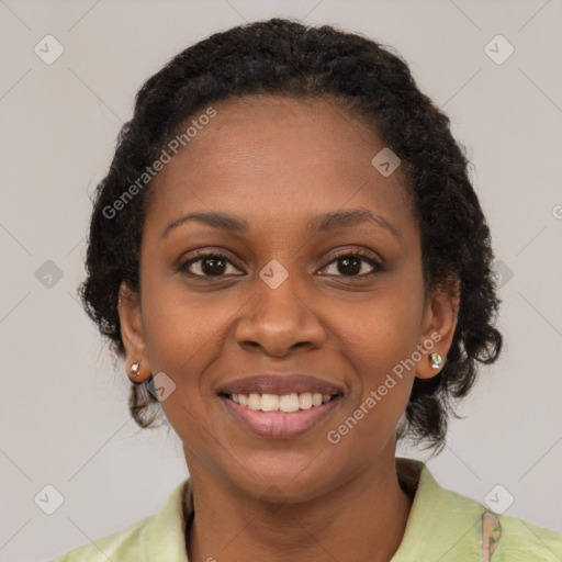 Joyful black young-adult female with medium  brown hair and brown eyes