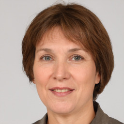 Joyful white adult female with medium  brown hair and grey eyes