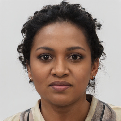 Joyful black young-adult female with medium  brown hair and brown eyes