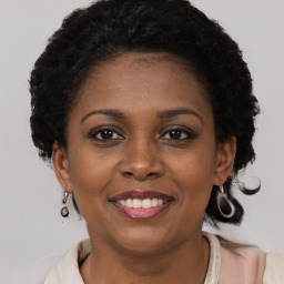 Joyful black young-adult female with short  brown hair and brown eyes