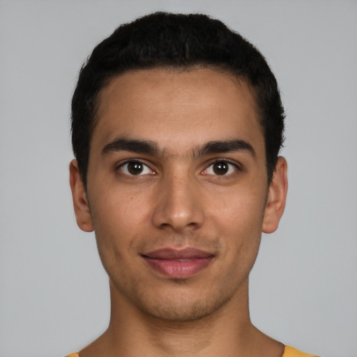 Joyful latino young-adult male with short  black hair and brown eyes