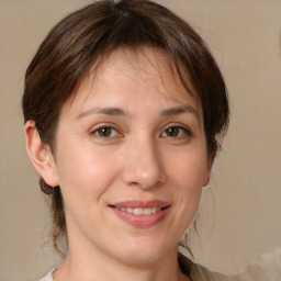 Joyful white young-adult female with medium  brown hair and brown eyes