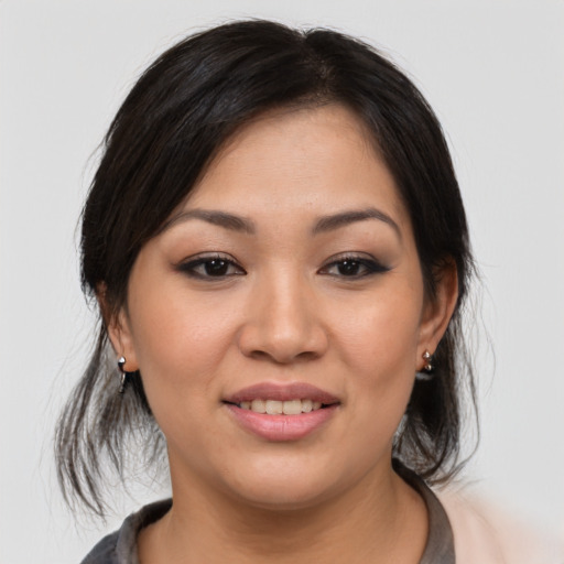 Joyful asian young-adult female with medium  black hair and brown eyes