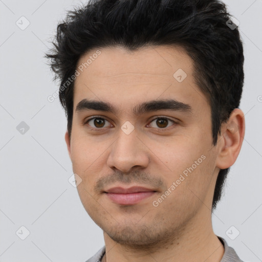 Joyful white young-adult male with short  black hair and brown eyes