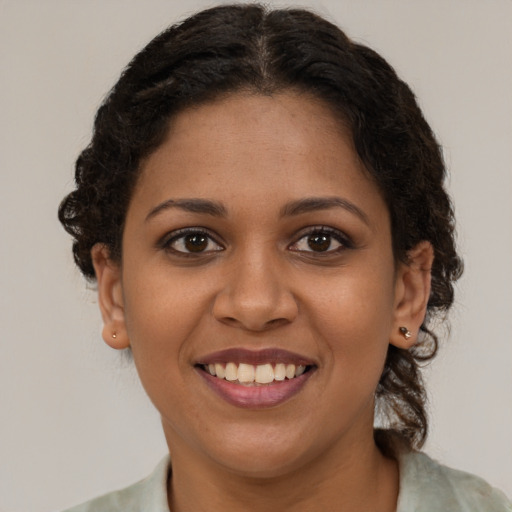 Joyful black young-adult female with medium  brown hair and brown eyes