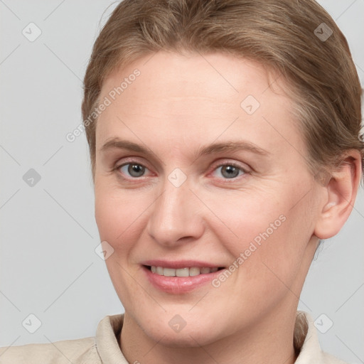 Joyful white young-adult female with short  brown hair and grey eyes