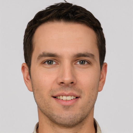 Joyful white young-adult male with short  brown hair and brown eyes