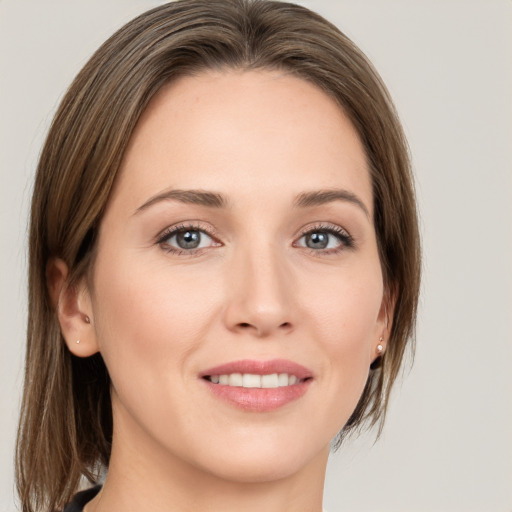 Joyful white young-adult female with medium  brown hair and grey eyes