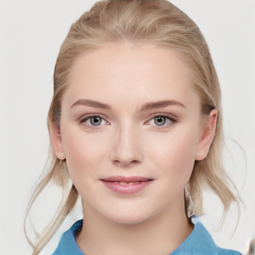 Joyful white young-adult female with medium  brown hair and blue eyes