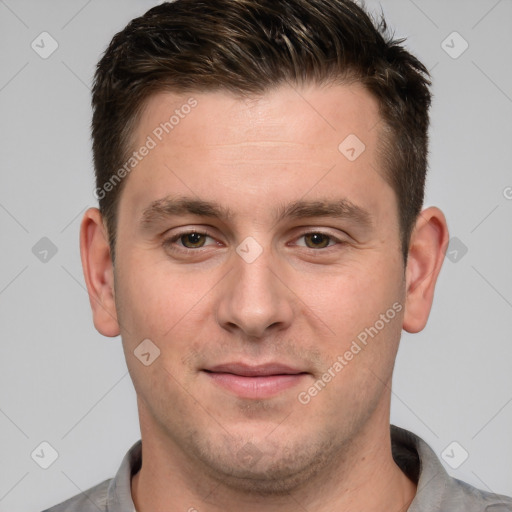 Joyful white young-adult male with short  brown hair and grey eyes