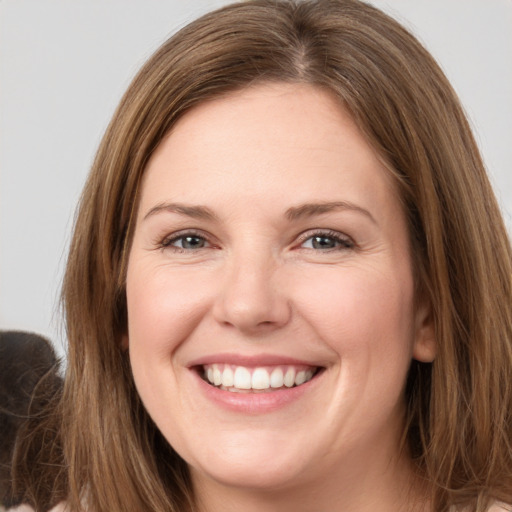 Joyful white young-adult female with long  brown hair and grey eyes