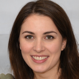 Joyful white adult female with long  brown hair and brown eyes