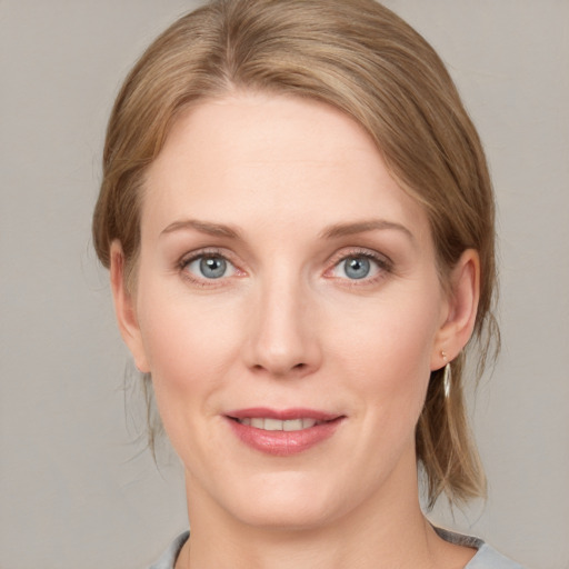 Joyful white young-adult female with medium  brown hair and blue eyes