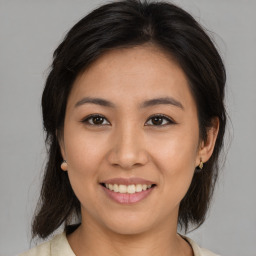 Joyful asian young-adult female with medium  brown hair and brown eyes