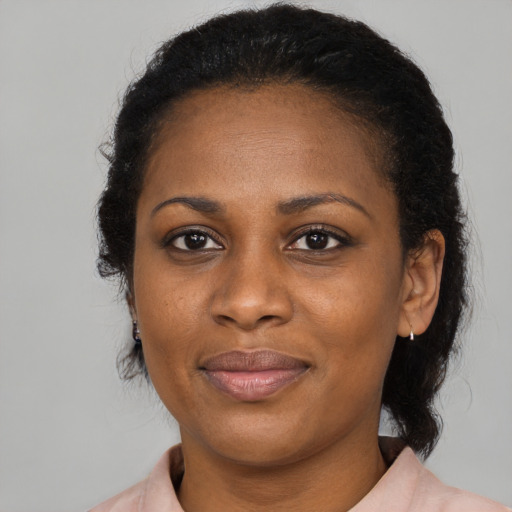 Joyful black adult female with medium  black hair and brown eyes
