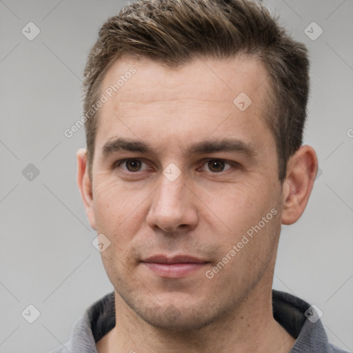 Joyful white young-adult male with short  brown hair and grey eyes