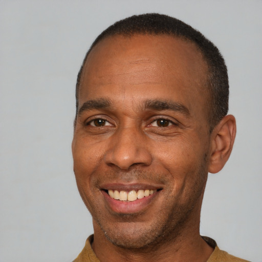 Joyful latino adult male with short  brown hair and brown eyes