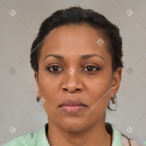 Joyful black adult female with short  brown hair and brown eyes