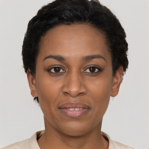 Joyful latino young-adult female with short  black hair and brown eyes