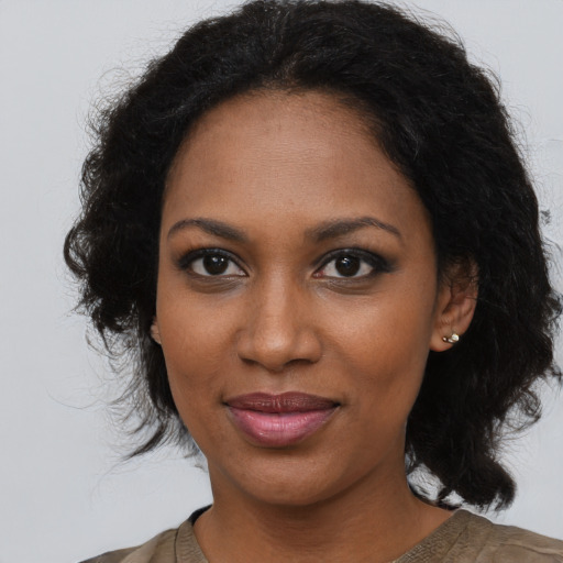 Joyful black young-adult female with medium  brown hair and brown eyes