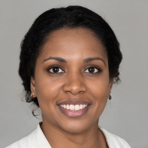 Joyful black young-adult female with medium  brown hair and brown eyes