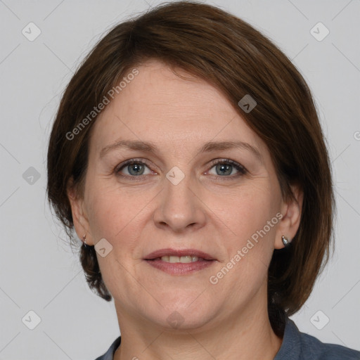 Joyful white adult female with medium  brown hair and grey eyes