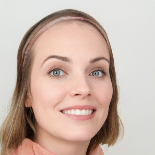 Joyful white young-adult female with long  brown hair and blue eyes