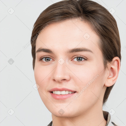 Joyful white young-adult female with medium  brown hair and grey eyes