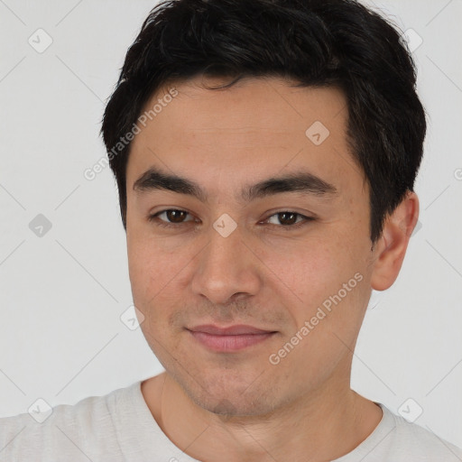 Joyful asian young-adult male with short  brown hair and brown eyes