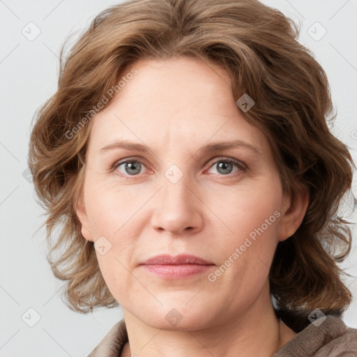 Joyful white adult female with medium  brown hair and blue eyes