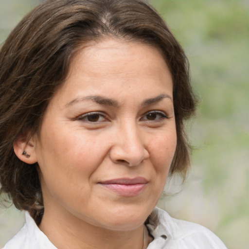 Joyful white adult female with medium  brown hair and brown eyes