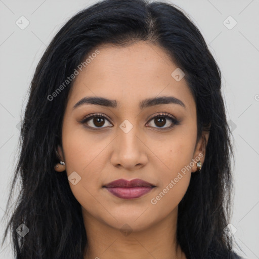 Joyful latino young-adult female with long  brown hair and brown eyes