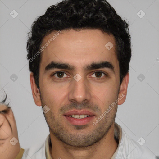 Joyful white young-adult male with short  black hair and brown eyes