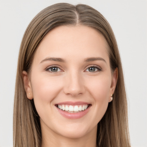 Joyful white young-adult female with long  brown hair and grey eyes