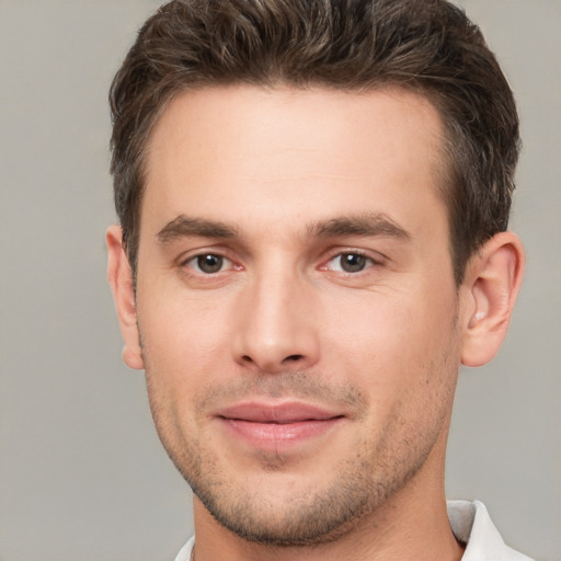 Joyful white young-adult male with short  brown hair and brown eyes