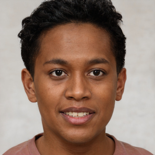 Joyful black young-adult male with short  brown hair and brown eyes
