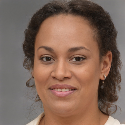 Joyful black young-adult female with medium  brown hair and brown eyes
