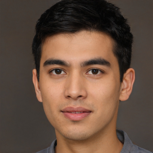 Joyful asian young-adult male with short  brown hair and brown eyes