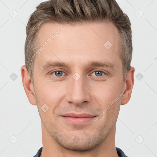 Joyful white young-adult male with short  brown hair and grey eyes