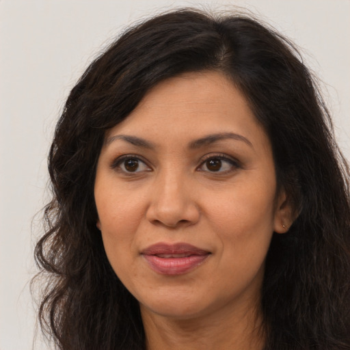 Joyful asian adult female with long  brown hair and brown eyes
