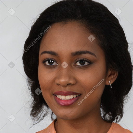 Joyful black young-adult female with long  black hair and brown eyes