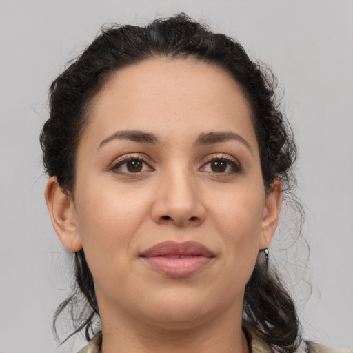 Joyful latino young-adult female with medium  brown hair and brown eyes