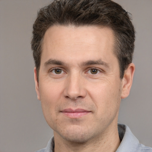 Joyful white adult male with short  brown hair and brown eyes