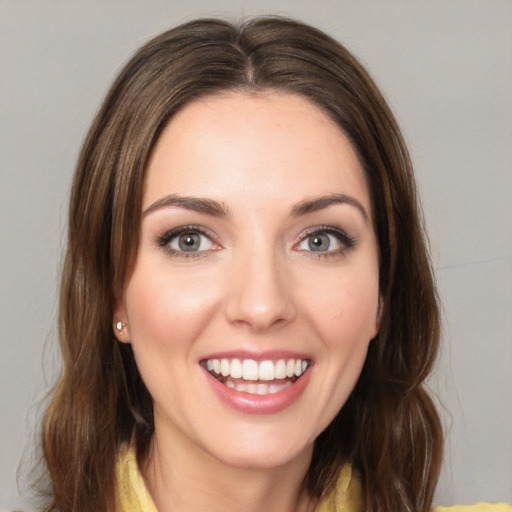 Joyful white young-adult female with medium  brown hair and blue eyes