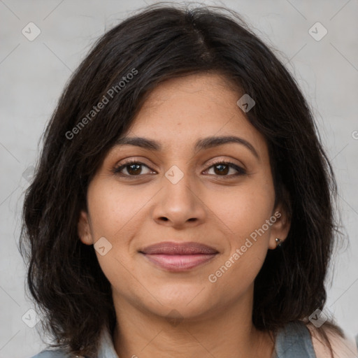 Joyful latino young-adult female with medium  brown hair and brown eyes