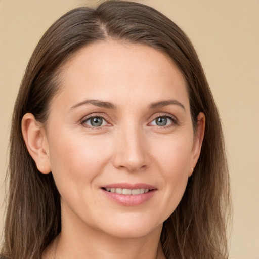 Joyful white young-adult female with long  brown hair and grey eyes