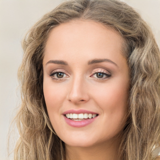 Joyful white young-adult female with long  brown hair and green eyes