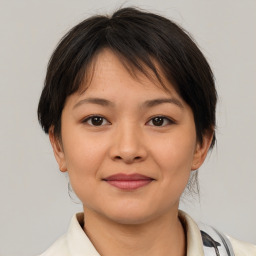 Joyful asian young-adult female with medium  brown hair and brown eyes