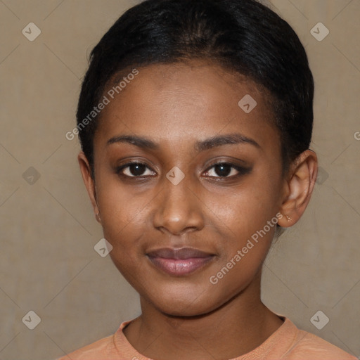 Joyful black young-adult female with short  black hair and brown eyes