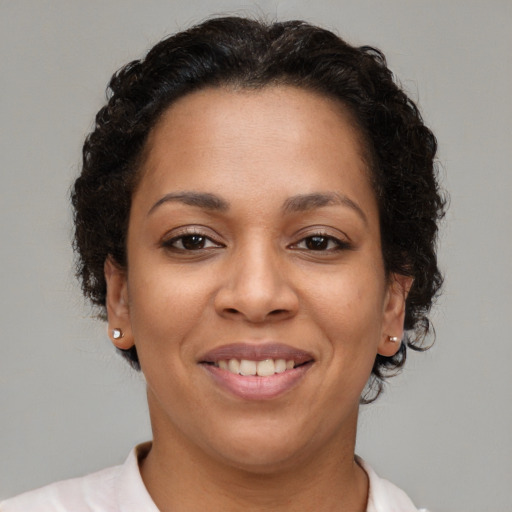 Joyful latino young-adult female with short  brown hair and brown eyes